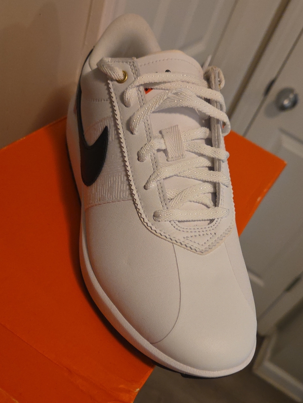 Nike Women’s White Sneakers with Black Swoosh and Subtle Gold Eyelet
